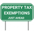 A green street sign that says "Property Tax Exemptions"