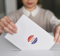 Image of a person submitting their ballot
