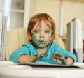 Child in high chair with messy face
