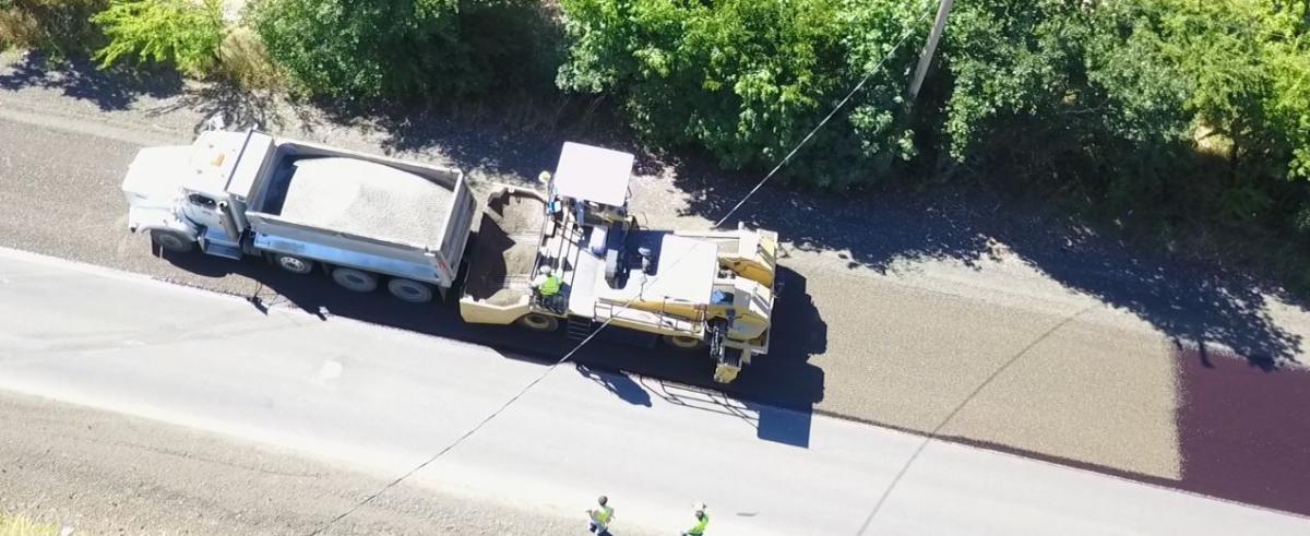 Chip Spreader Hooking Up to Dump Truck